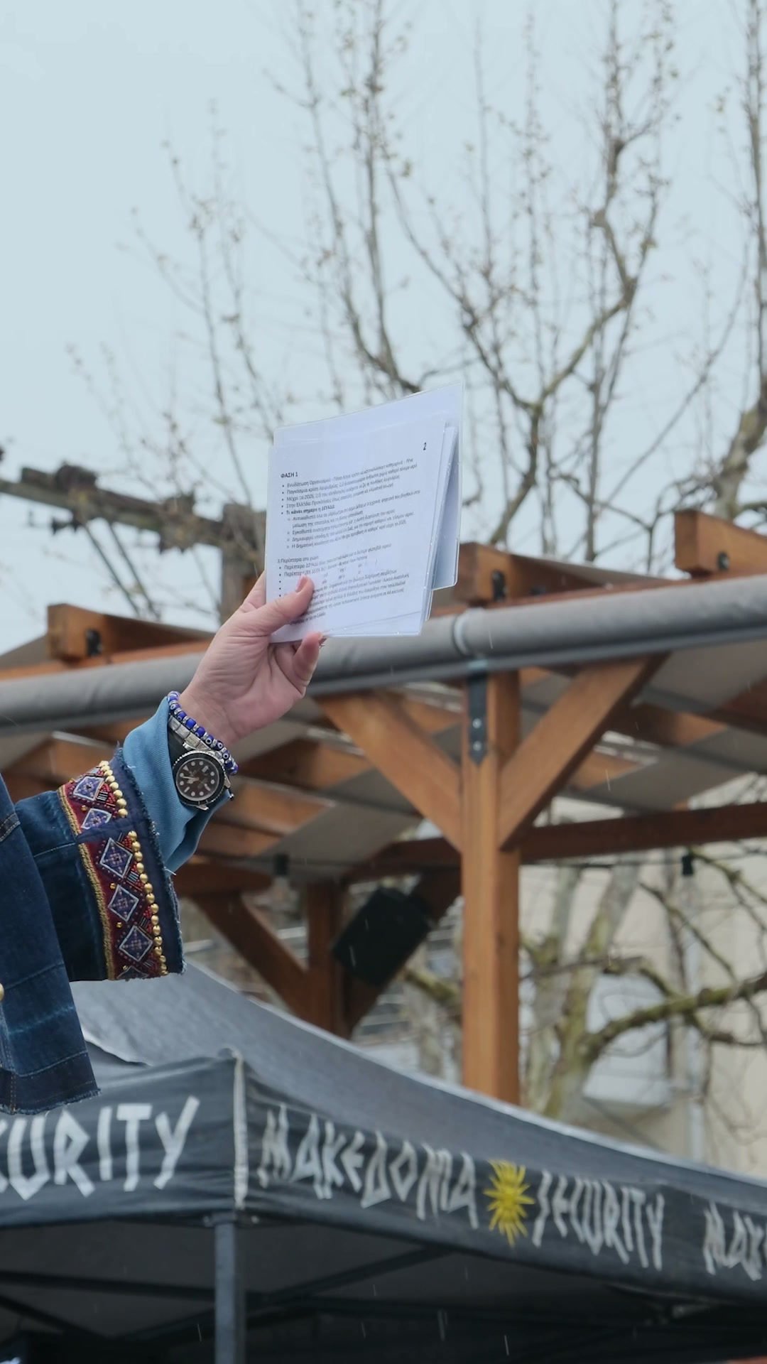 Event presenter holding notes at the Water Festival